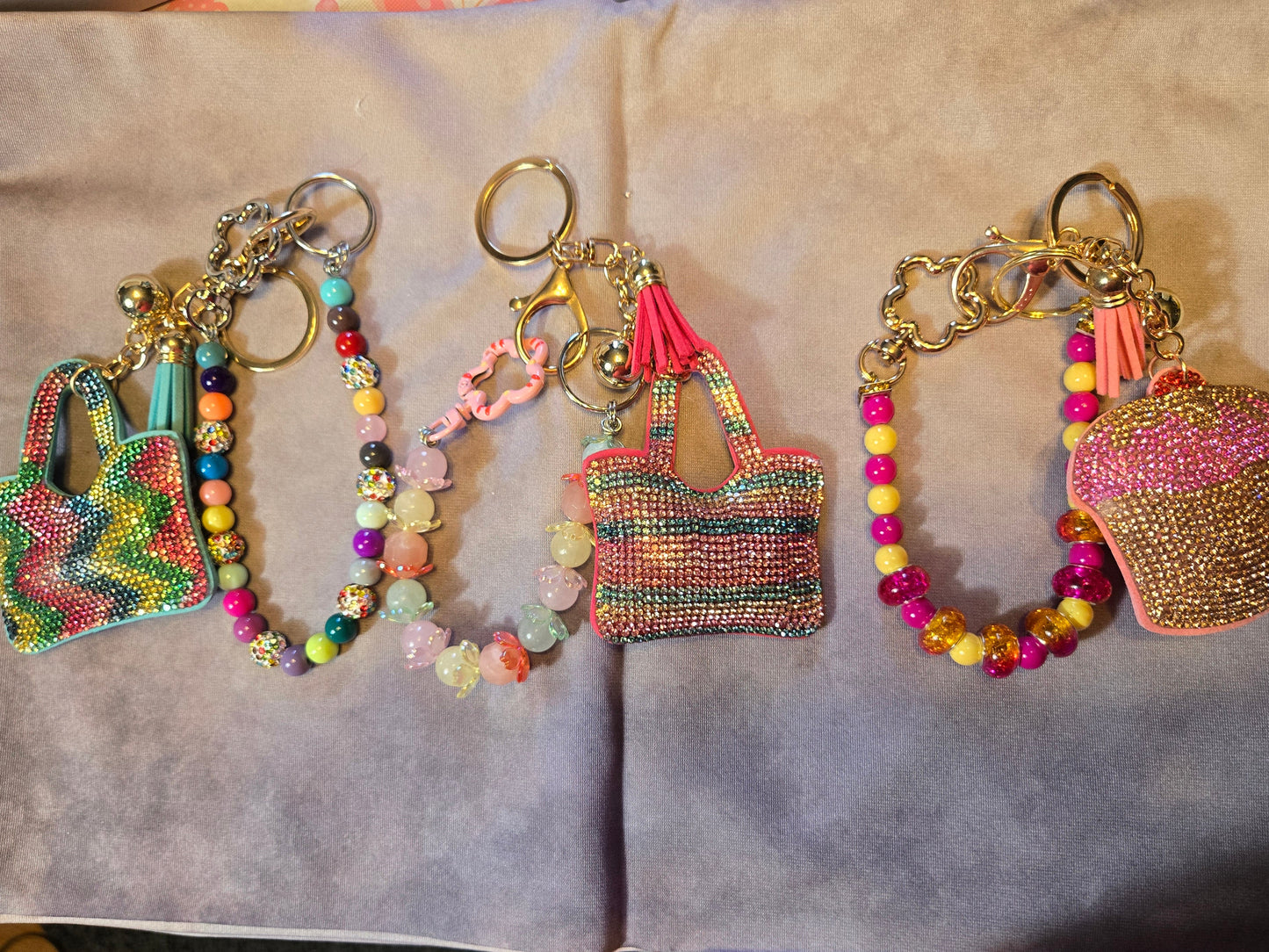 Colorful keychains shaped like handbags and a cupcake 