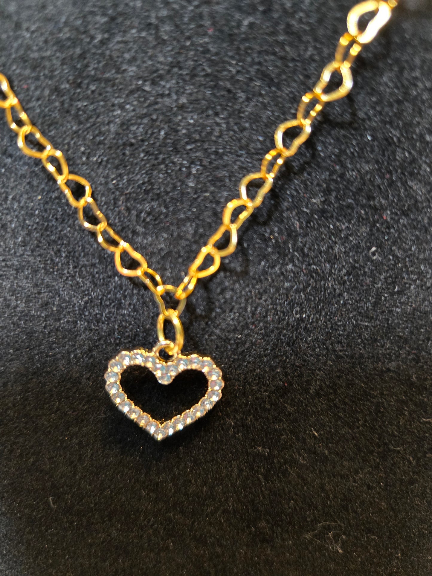 Gold tone necklace with a heart-shaped pendant