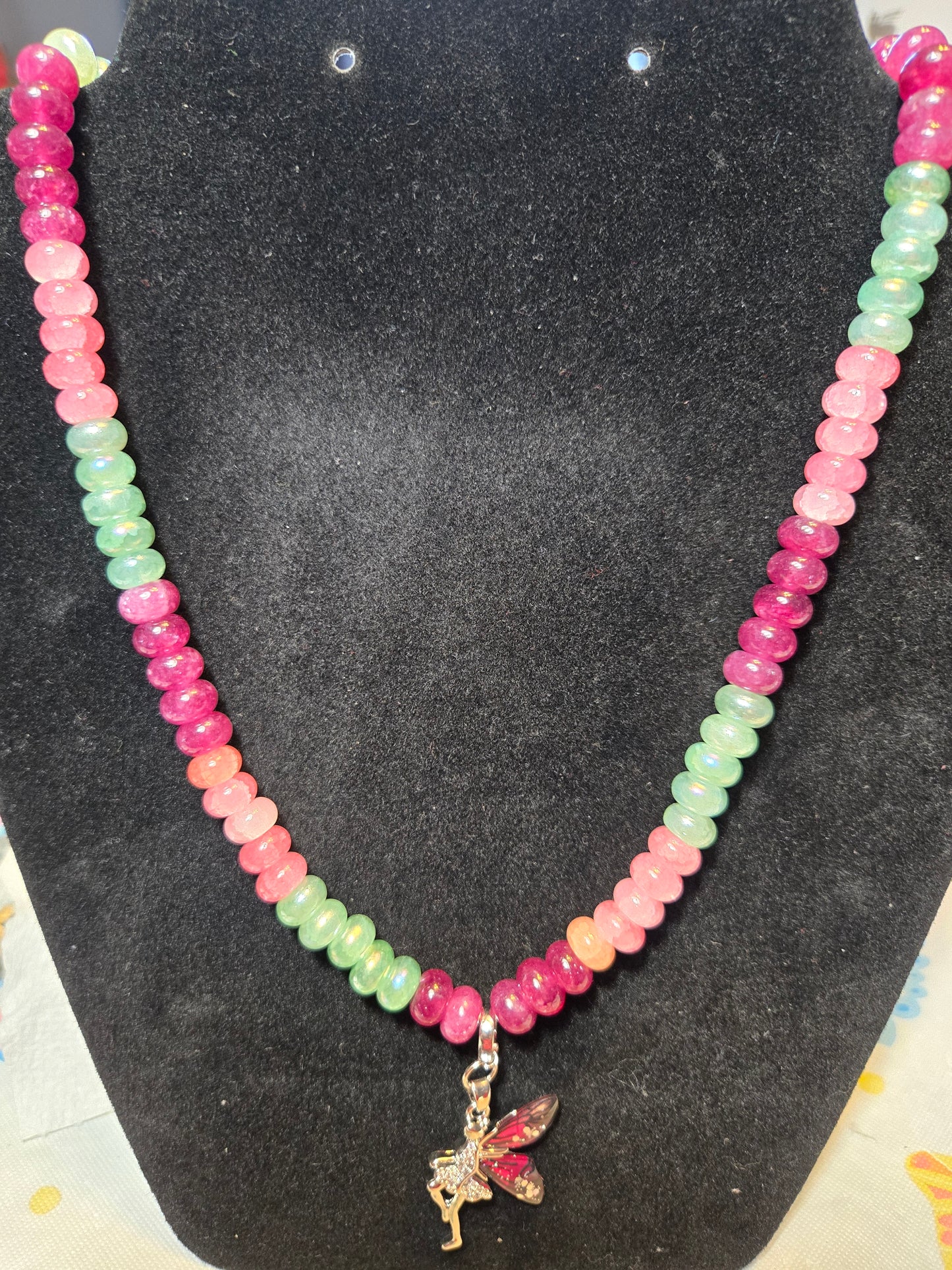 Multicolored, donut beaded necklace with fairy pendant