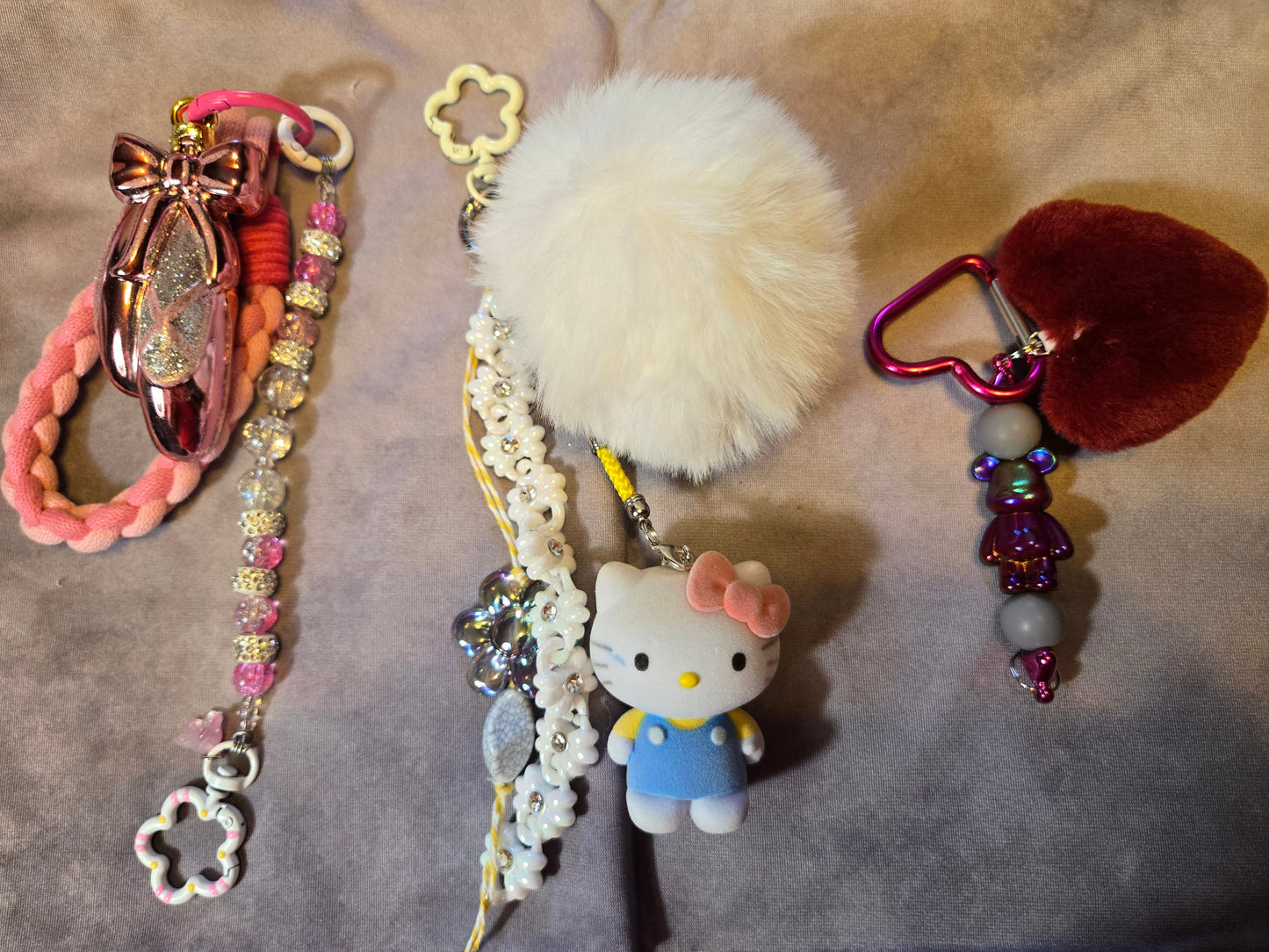 Collection of decorative keychains: ballerina, HK and a bear.