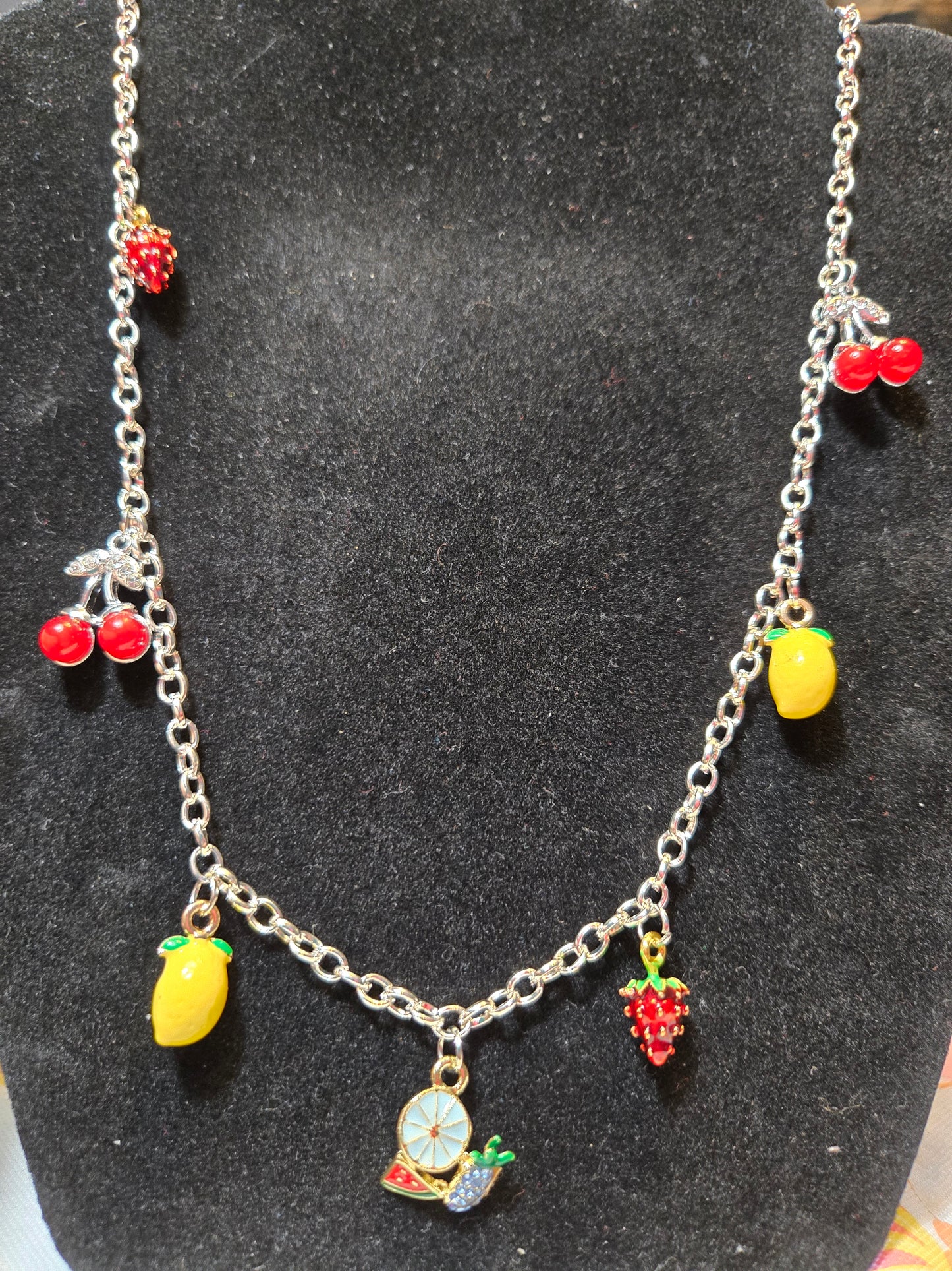 Silver metal necklace with fruit-shaped charms 